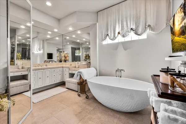 a view of a hallway with dining table and chairs