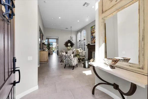 a living room with furniture flower pot and a fireplace