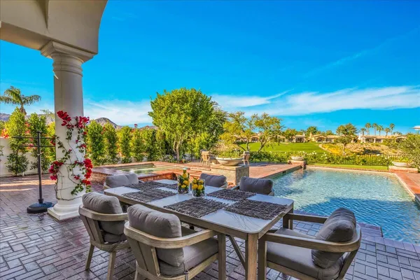 a view of a chairs and table in the patio