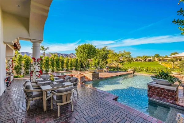 a view of a backyard tables and chairs