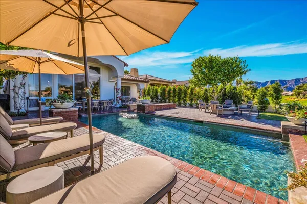 a view of a patio with table and chairs potted plants