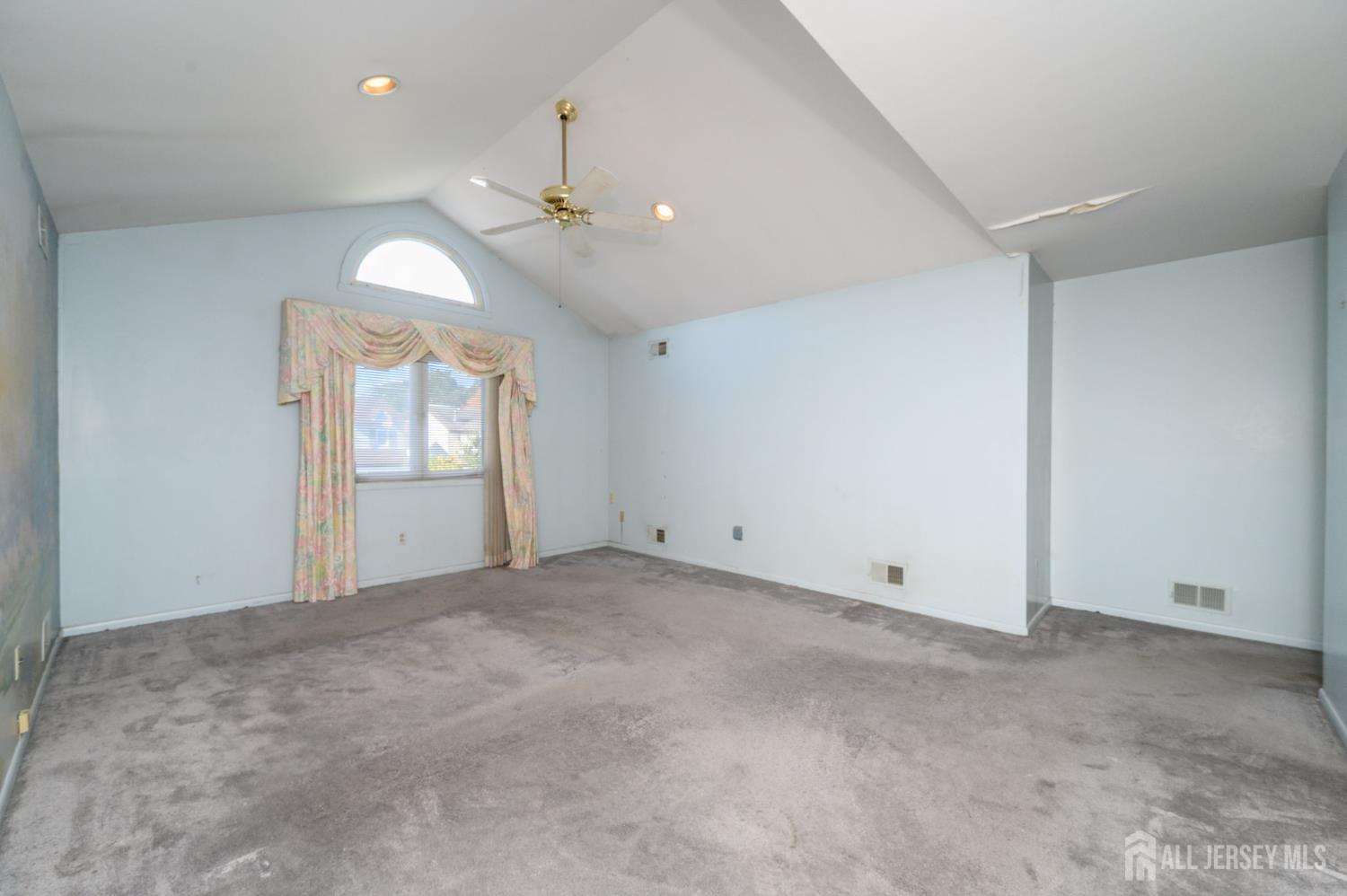 112 Apple Tree Lane Union, NJ 07083 - Photo 22 of 46 an empty room with chandelier fan and windows