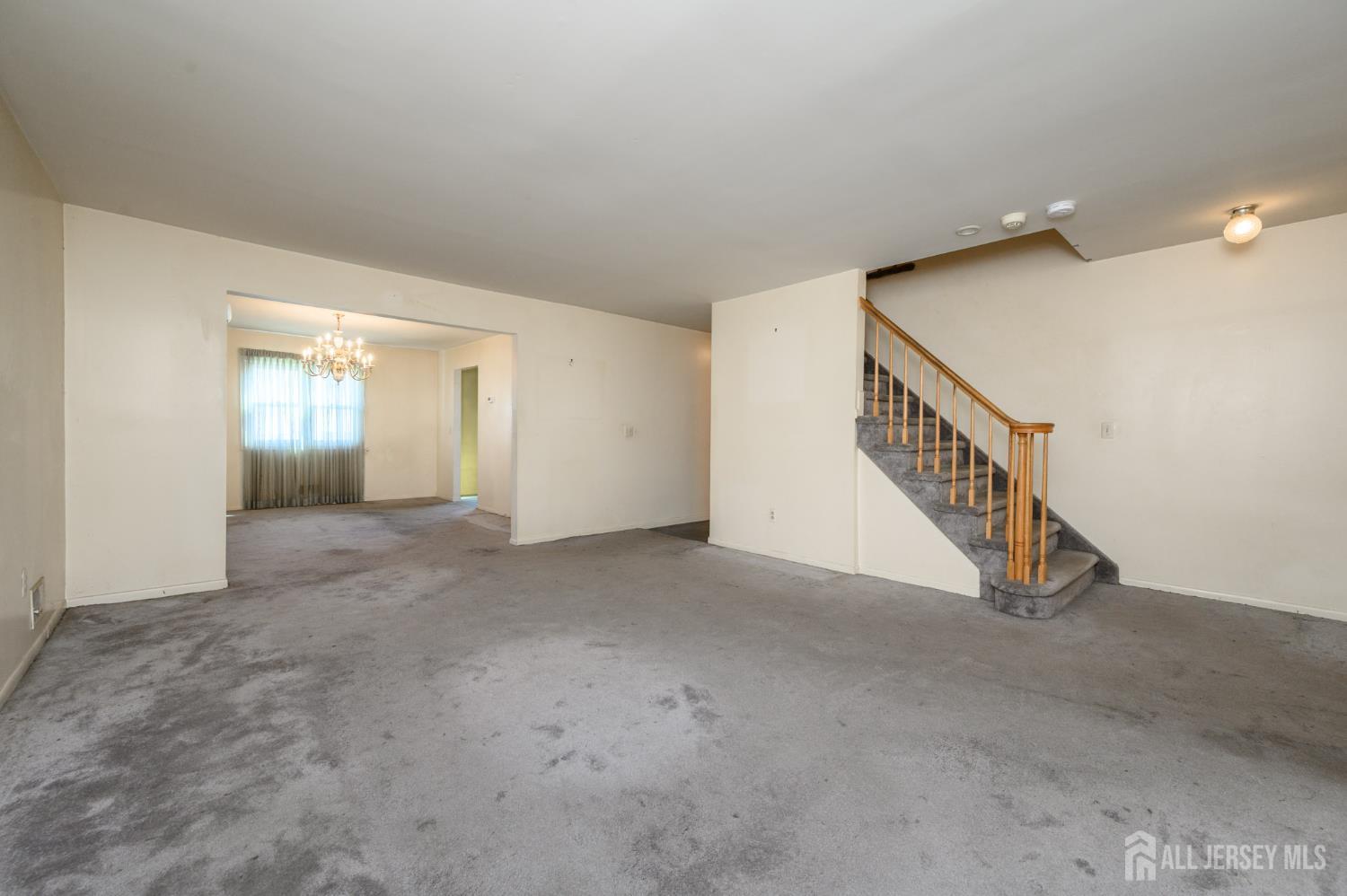 112 Apple Tree Lane Union, NJ 07083 - Photo 6 of 46 a view of an empty room with stairs and a ceiling fan