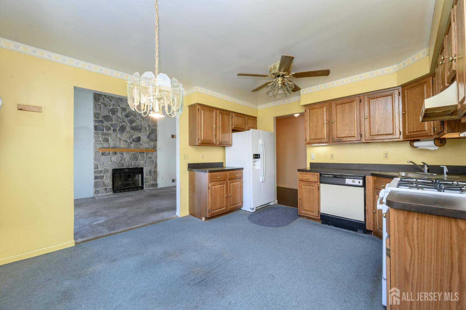 112 Apple Tree Lane Union, NJ 07083 - Photo 9 of 46 a kitchen with refrigerator a stove and a chandelier
