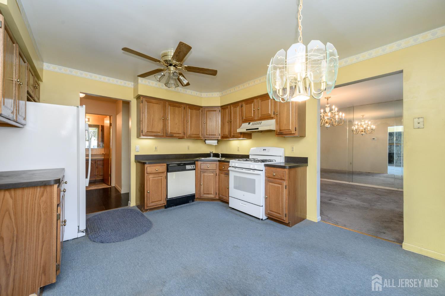 112 Apple Tree Lane Union, NJ 07083 - Photo 10 of 46 a kitchen with a chandelier stainless steel appliances cabinets and a counter top space
