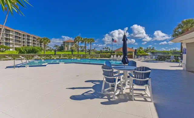 a view of a swimming pool and lounge chairs