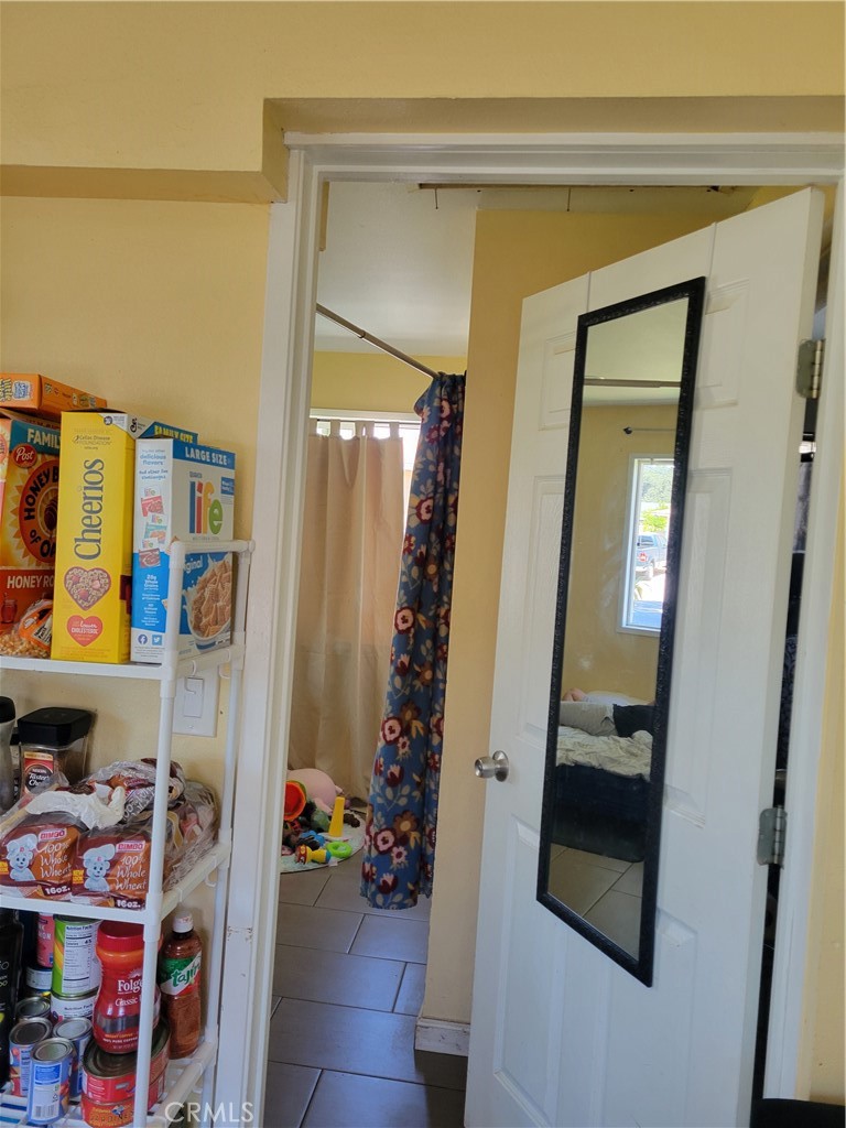 5240 Appleton Street Riverside, CA 92504 - Photo 14 of 16 a view of an entryway with wooden floor and a cabinet