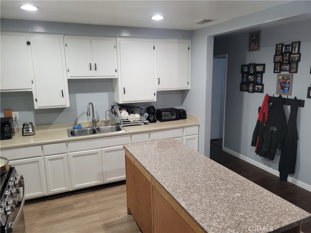 5240 Appleton Street Riverside, CA 92504 - Photo 6 of 16 a kitchen with stainless steel appliances granite countertop a sink stove and cabinets