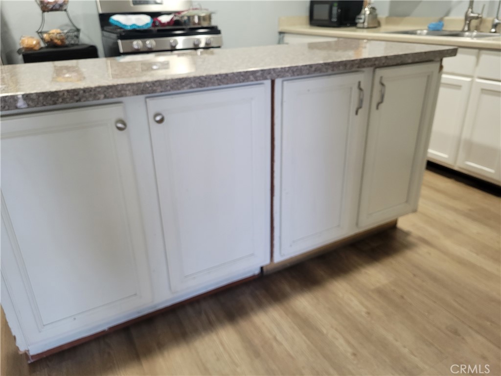 5240 Appleton Street Riverside, CA 92504 - Photo 7 of 16 a view of cabinets with wooden floor