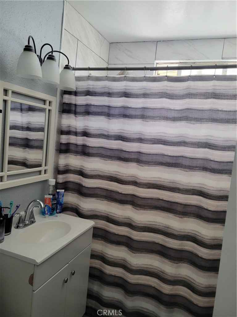 5240 Appleton Street Riverside, CA 92504 - Photo 9 of 16 a bathroom with a sink and a mirror