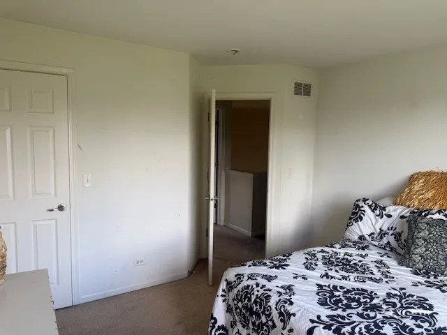 a bedroom with a bed and a cabinets
