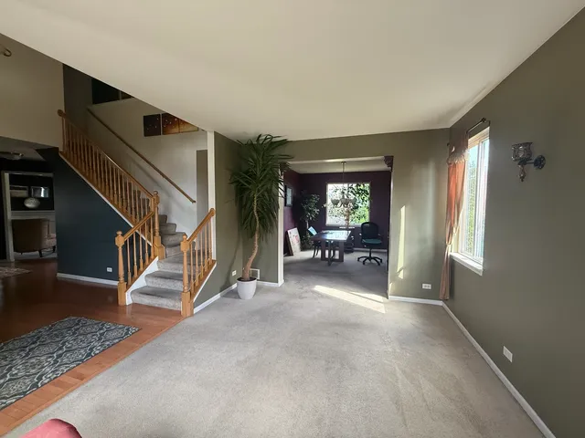 a view of a livingroom with furniture and stairs