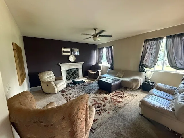 a living room with furniture a fireplace and a flat screen tv