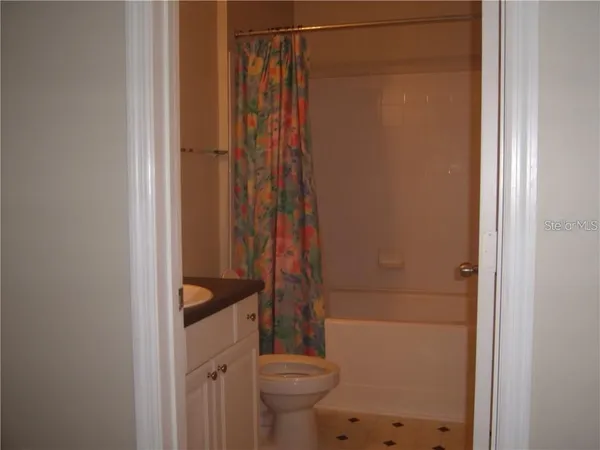 a bathroom with a shower toilet and sink