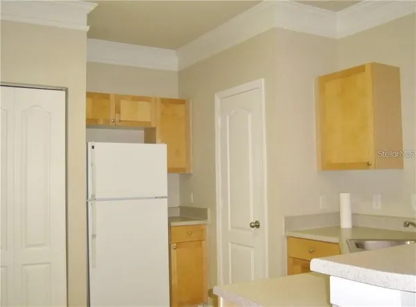 a white refrigerator freezer sitting in a kitchen