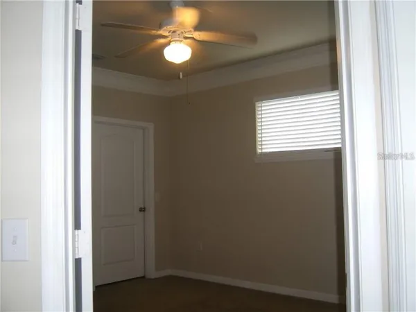 a view of a livingroom with a chandelier fan