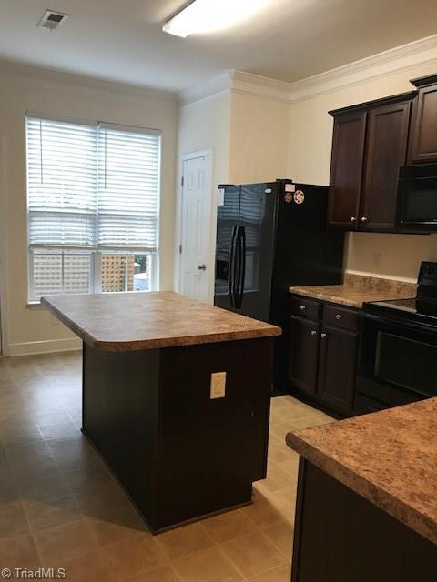 3770 Shadow Ridge Drive High Point, NC 27265 - Photo 7 of 26 Island bar in kitchen, Refrigerator , Range, Microwave and dishwasher to remain