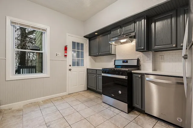 a kitchen with a refrigerator stove and sink