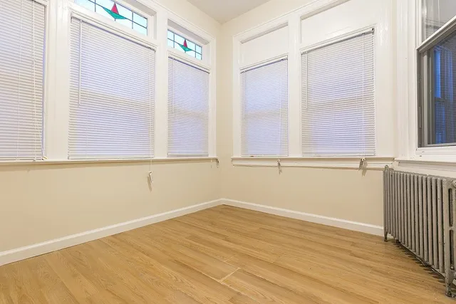 a view of a room with wooden floor and windows