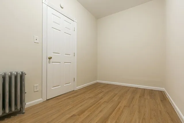 a kitchen with granite countertop a stove top oven and cabinets