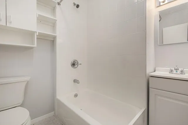 a bathroom with a sink toilet and vanity