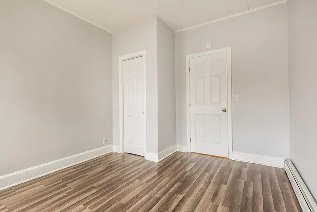 a view of an empty room and wooden floor