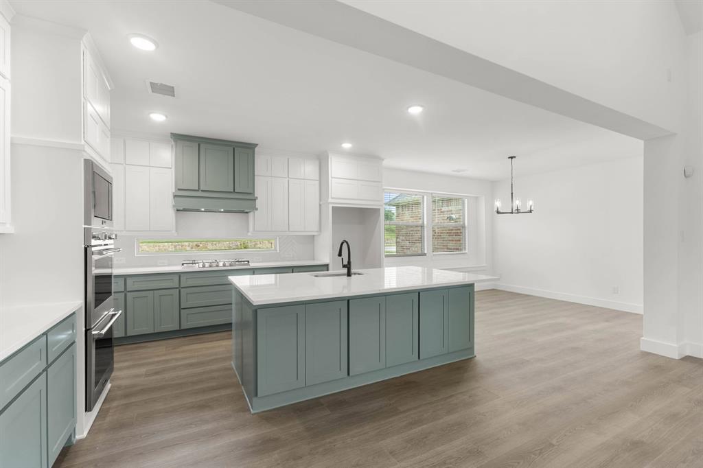 413 Tower Street DeSoto, TX 75115 - Photo 13 of 30 a kitchen with kitchen island sink stove and refrigerator