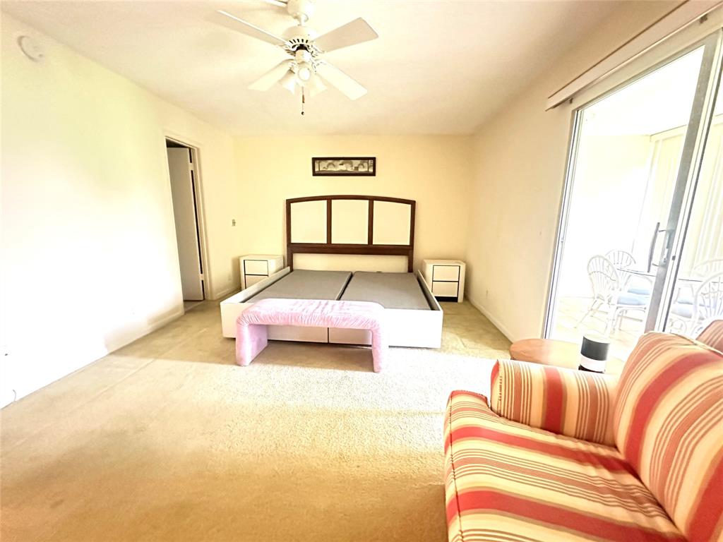 2009 Berkshire A, Unit 2009 Deerfield Beach, FL 33442 - Photo 13 of 57 a bedroom with a bed and a window