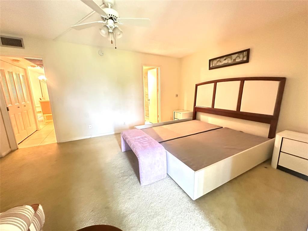 2009 Berkshire A, Unit 2009 Deerfield Beach, FL 33442 - Photo 15 of 57 a bedroom with a bed and a window