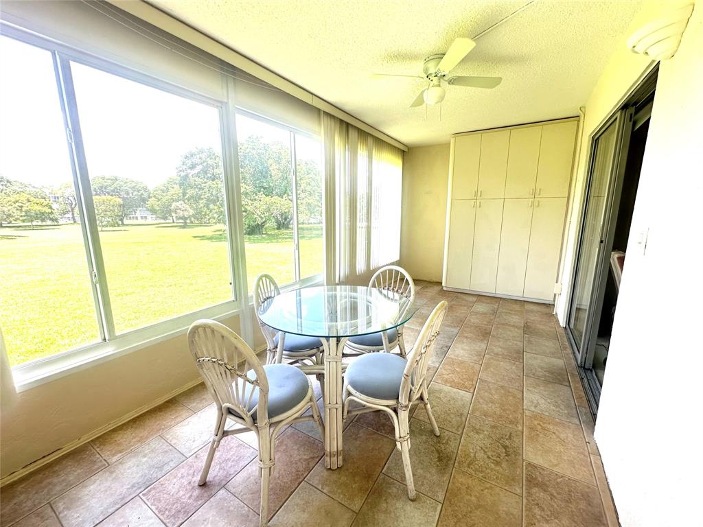 2009 Berkshire A, Unit 2009 Deerfield Beach, FL 33442 - Photo 20 of 57 a view of a dining room with furniture window and outside view