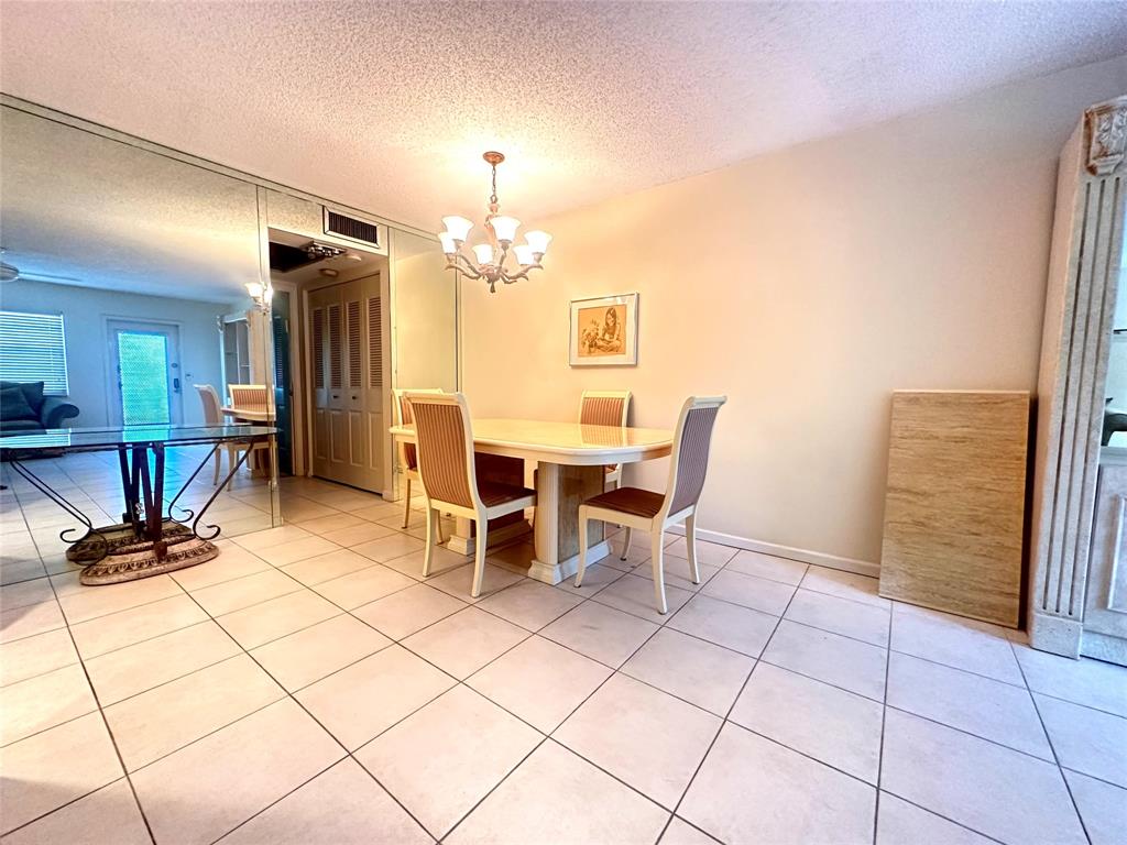 2009 Berkshire A, Unit 2009 Deerfield Beach, FL 33442 - Photo 5 of 57 a view of a dining room with furniture