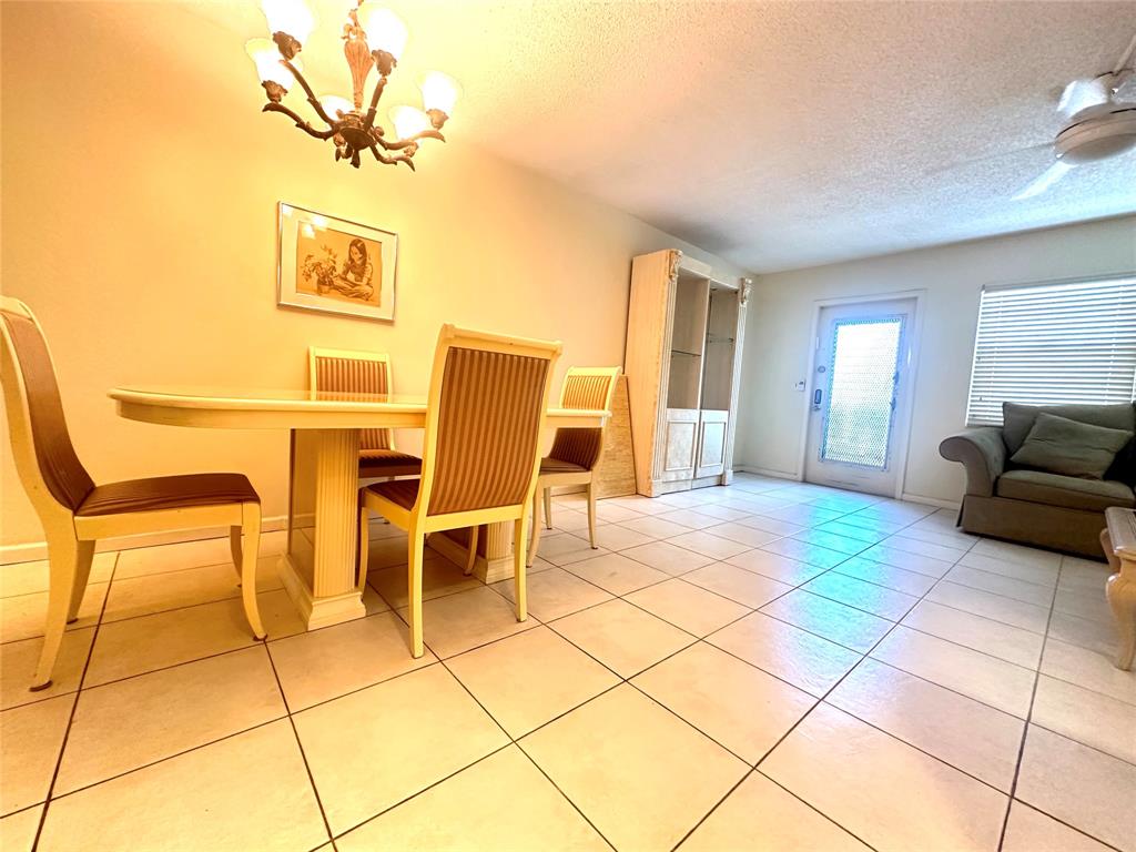 2009 Berkshire A, Unit 2009 Deerfield Beach, FL 33442 - Photo 6 of 57 a view of a livingroom with furniture and a window