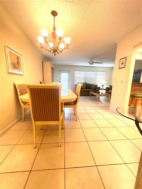 2009 Berkshire A, Unit 2009 Deerfield Beach, FL 33442 - Photo 7 of 57 a view of a dining room with furniture and a chandelier