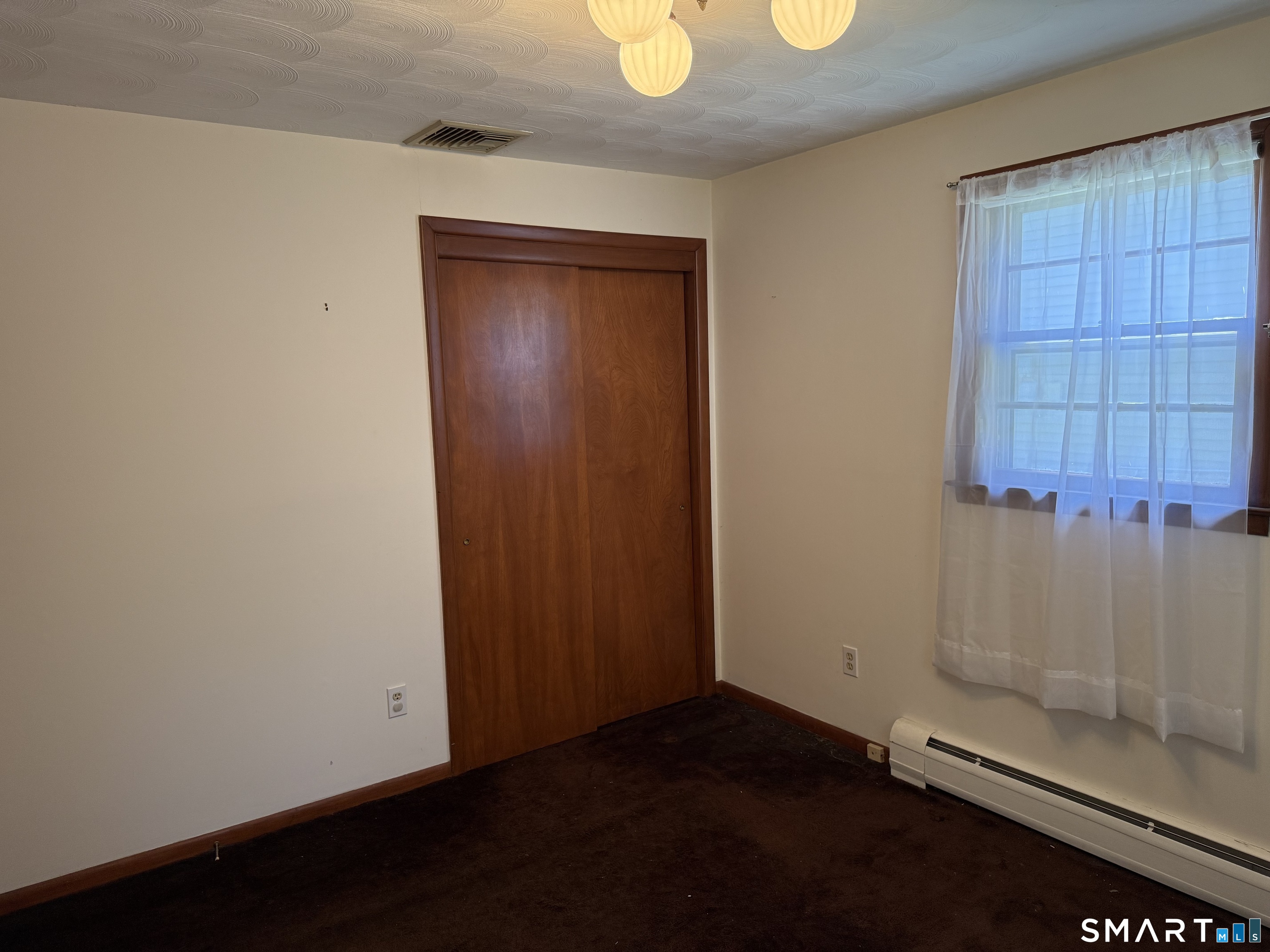 26 Maple Street Trumbull, CT 06611 - Photo 26 of 37 an empty room with a wooden door