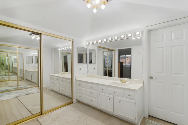 a spacious bathroom with a double vanity sink and a mirror
