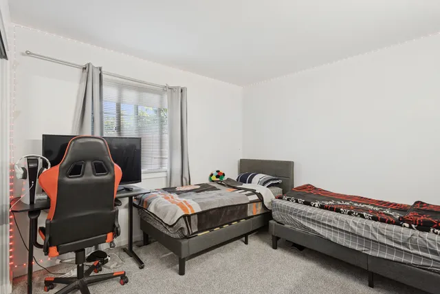 a bedroom with furniture and a window