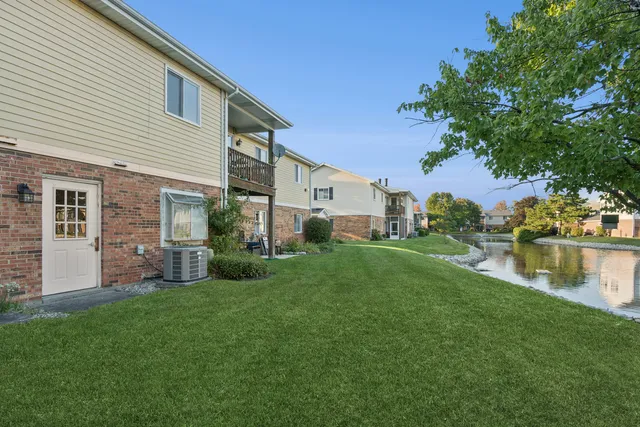 a view of a house with a yard and a patio