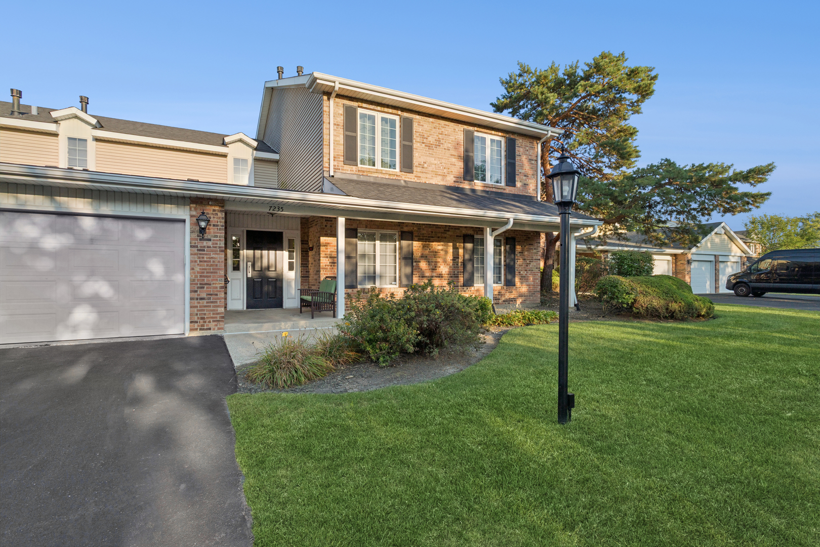 7235 Willow Way Lane, Unit B Willowbrook, IL 60527 - Photo 2 of 20 a front view of a house with a garden