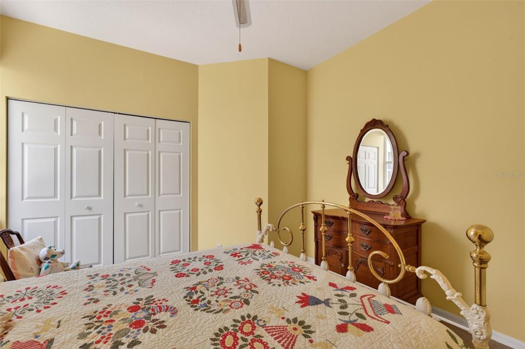 4266 Summertree Road Venice, FL 34293 - Photo 26 of 64 a bedroom with a bed a mirror and dresser