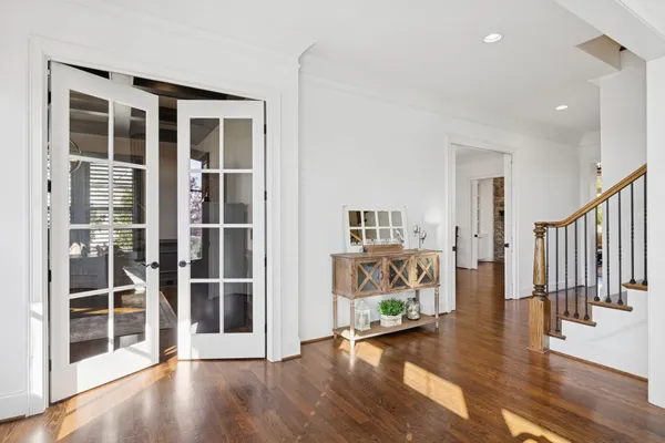 a living room with furniture kitchen and a chandelier