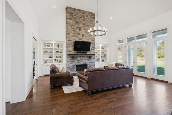 a kitchen with stove and wooden floor