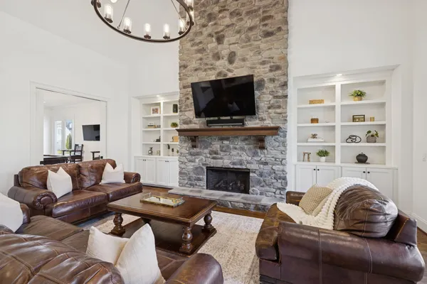 a bedroom with a large bed and a chandelier