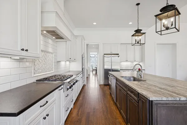 a bathroom with a double vanity sink a mirror and a bathtub