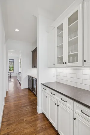 a bedroom with a bed next to a window with a chandelier