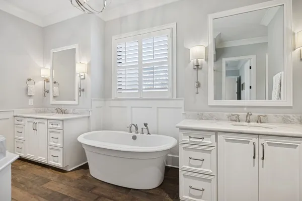 a view of a big house with a big yard plants and large trees