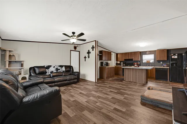 a living room with furniture kitchen and a kitchen view