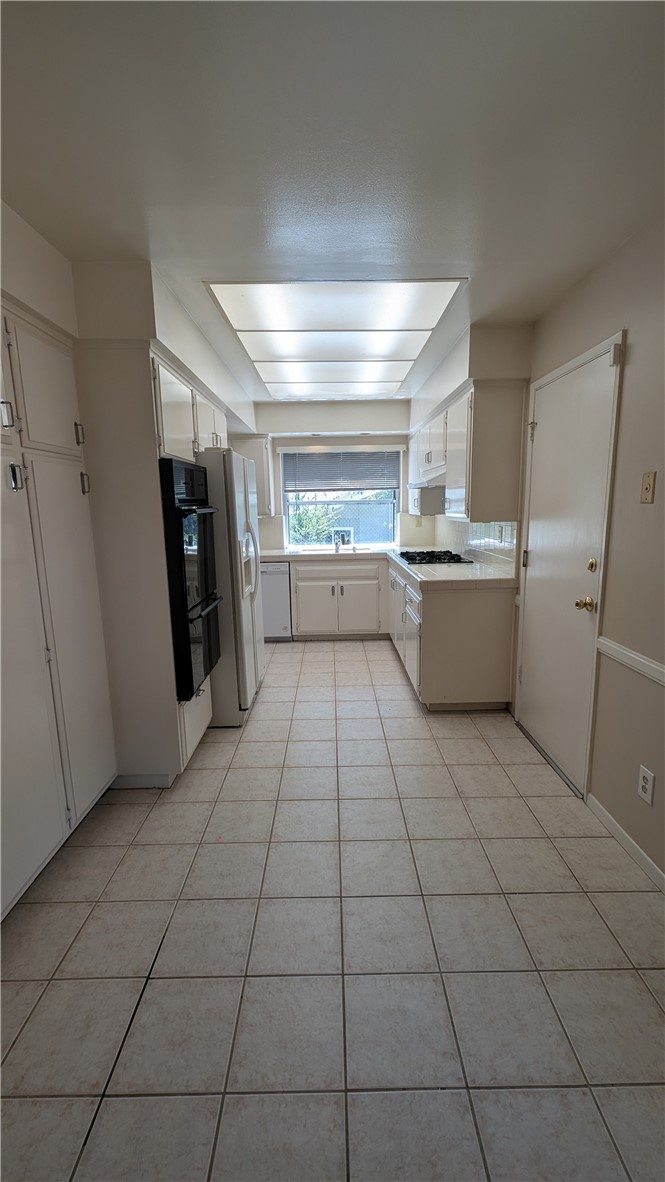 2566 Flanders Road Riverside, CA 92507 - Photo 5 of 16 a kitchen with stainless steel appliances a refrigerator and a stove top oven