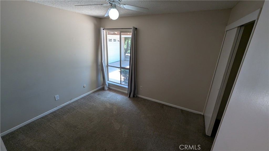 2566 Flanders Road Riverside, CA 92507 - Photo 9 of 16 an empty room with chandelier fan