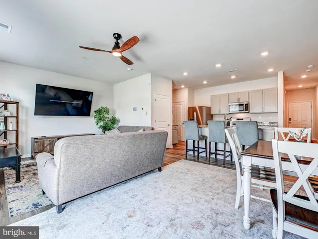a living room with furniture and kitchen view