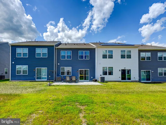 a front view of a building with garden and entryway